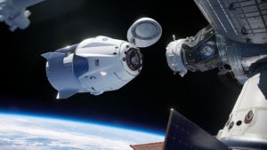 Simulaci&oacute; de la c&agrave;psula Crew Dragon aproximant-se a l'Estaci&oacute; Espacial Internacional